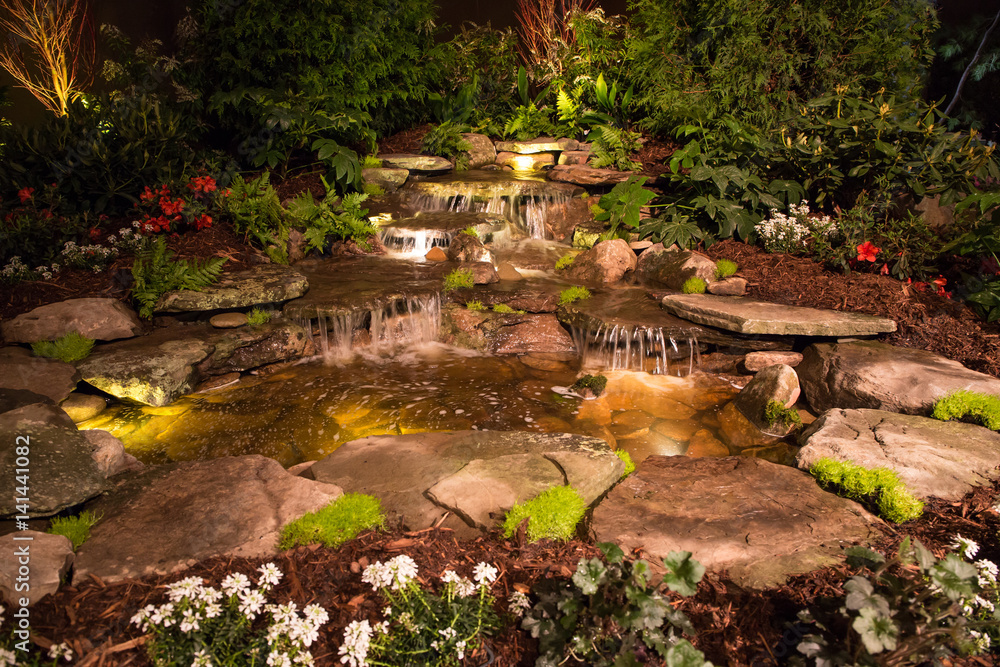 Fototapeta premium Dramatically lit waterfall at night