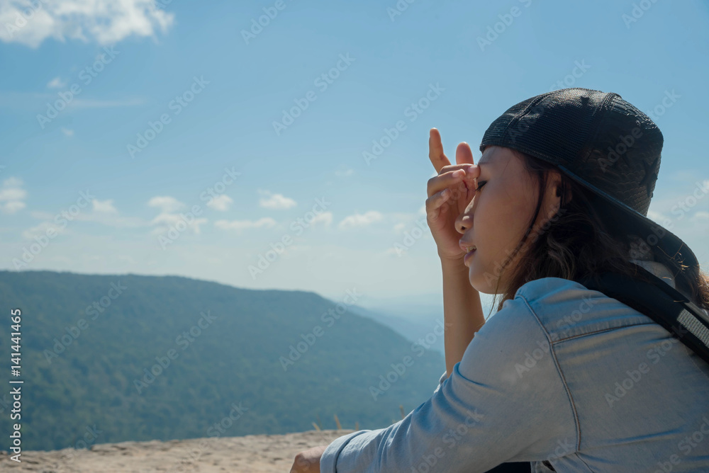 woman hiking sit down enjoy the beautiful view at mountain for sun light