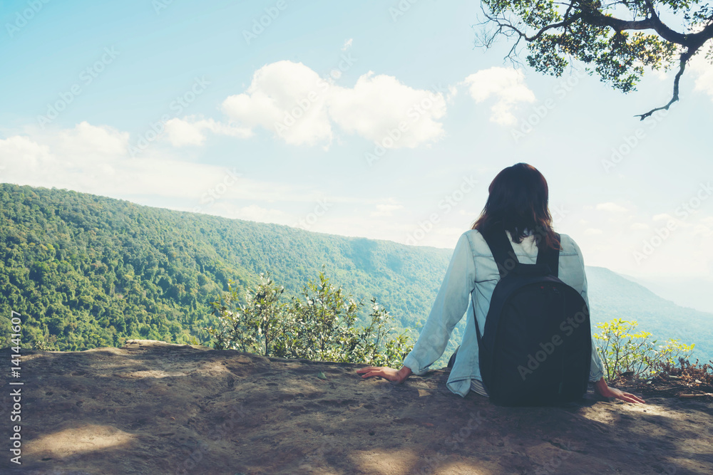 Fototapeta premium woman hiking sit down enjoy the beautiful view at mountain for sun light
