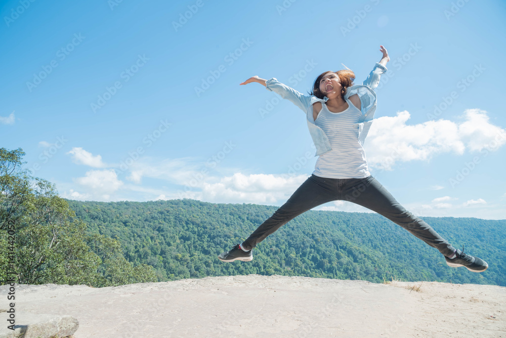 young woman Jumping at mountain view for sun light young woman Jumping at mountain view for sun light