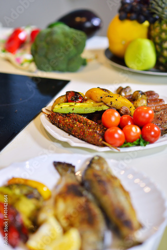 Grilled sausage with grilled vegetables on kitchen table