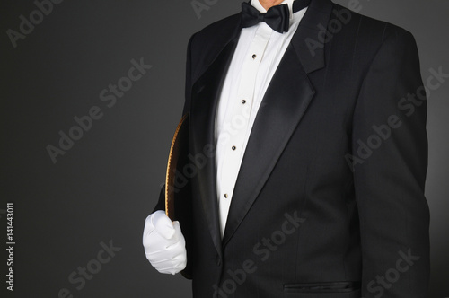 Waiter Holding Serving Tray Under His Arm photo