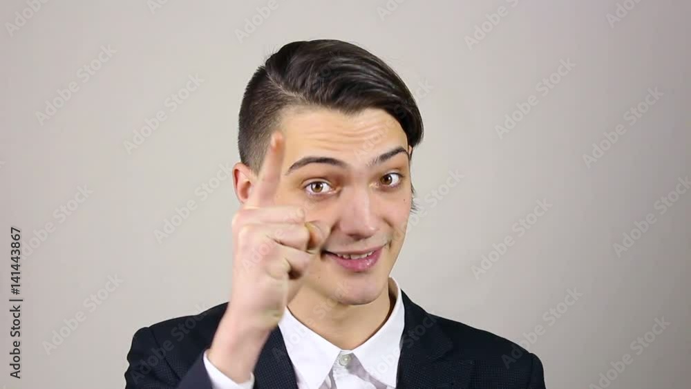 young businessman pointing finger at camera young businessman pointing finger at camera