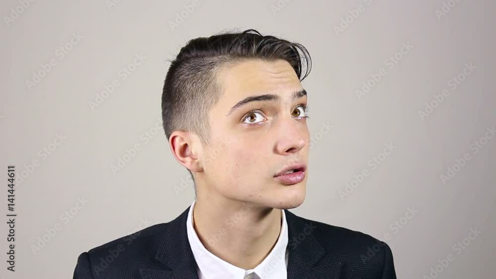 The young man knocks on the door and listens The young man knocks on the door and listens