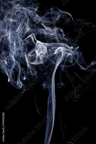 Fototapeta Naklejka Na Ścianę i Meble -  Abstract art. Color white blue smoke from the aromatic sticks on a black background. Background for Halloween. Texture fog. Design element. The concept of aromatherapy.