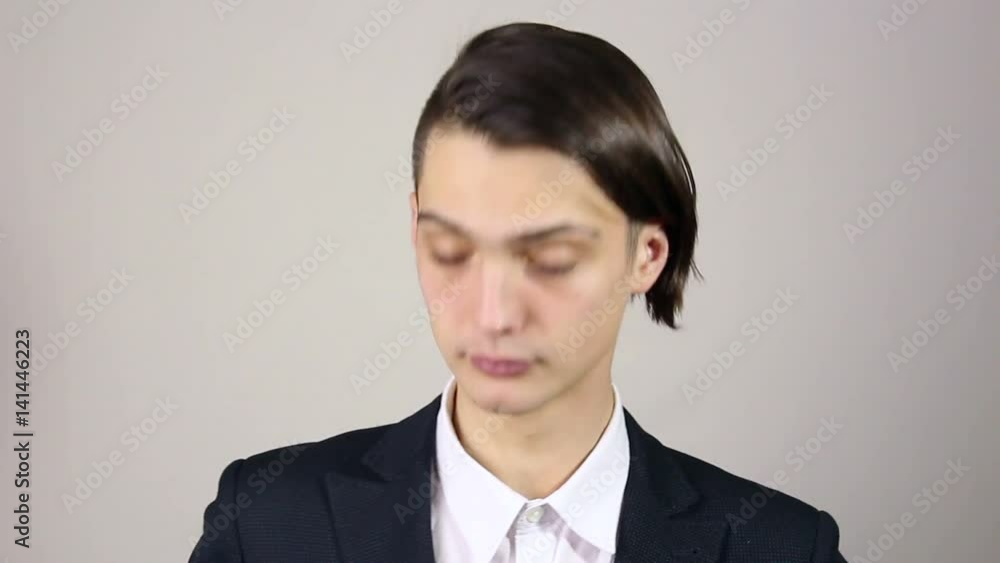 young man straightens of clothes, looking in the mirror. young man straightens of clothes, looking in the mirror.