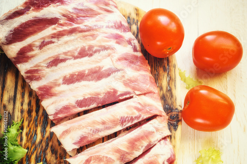 raw pork ribs on a cutting board