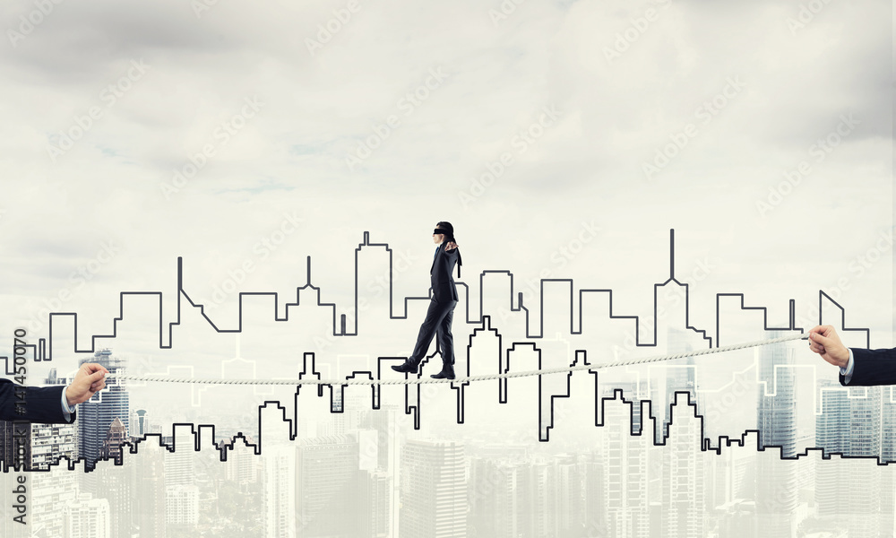 Business concept of risk support and assistance with man balancing on rope Business concept of risk support and assistance with man balancing on rope