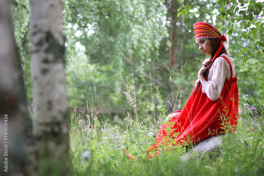 Slav in traditional dress is sitting in nature Slav in traditional dress is sitting in nature