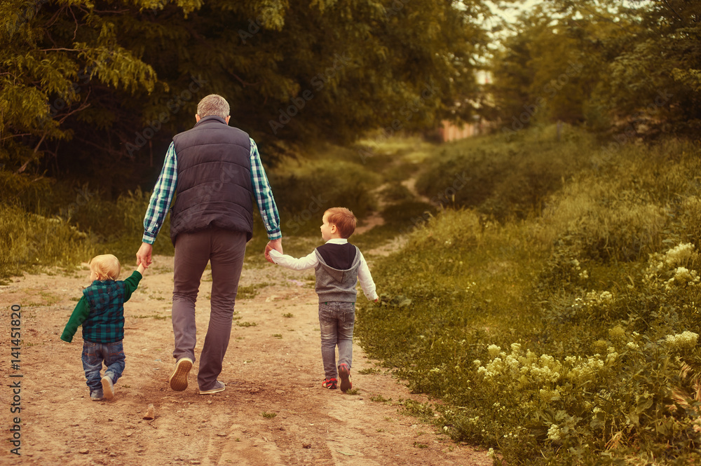 father walks with children in the Park father walks with children in the Park