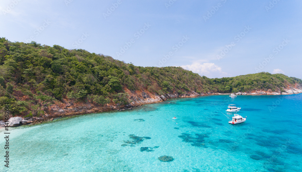 Blue water and Motor recreation boats on the tropical beach in the Racha Noi island Thailand Blue water and Motor recreation boats on the tropical beach in the Racha Noi island Thailand