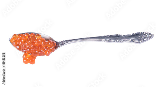 red caviar falls from a spoon on a white background