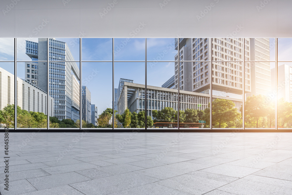 Fototapeta premium The modern office buildings from glass window