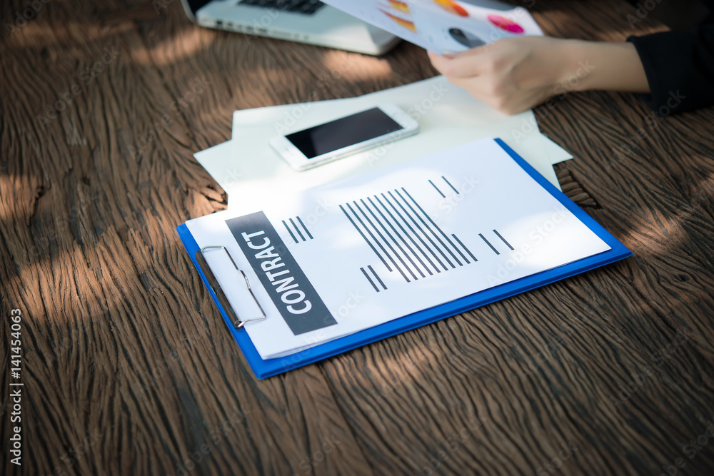 business woman working with documents graphs ,analyzing investment chart working in office. business woman working with documents graphs ,analyzing investment chart working in office.