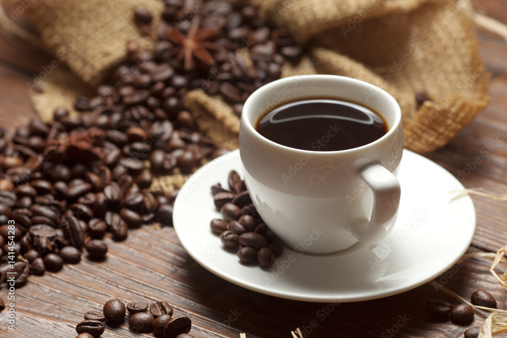 White cup of coffee with beans White cup of coffee with beans