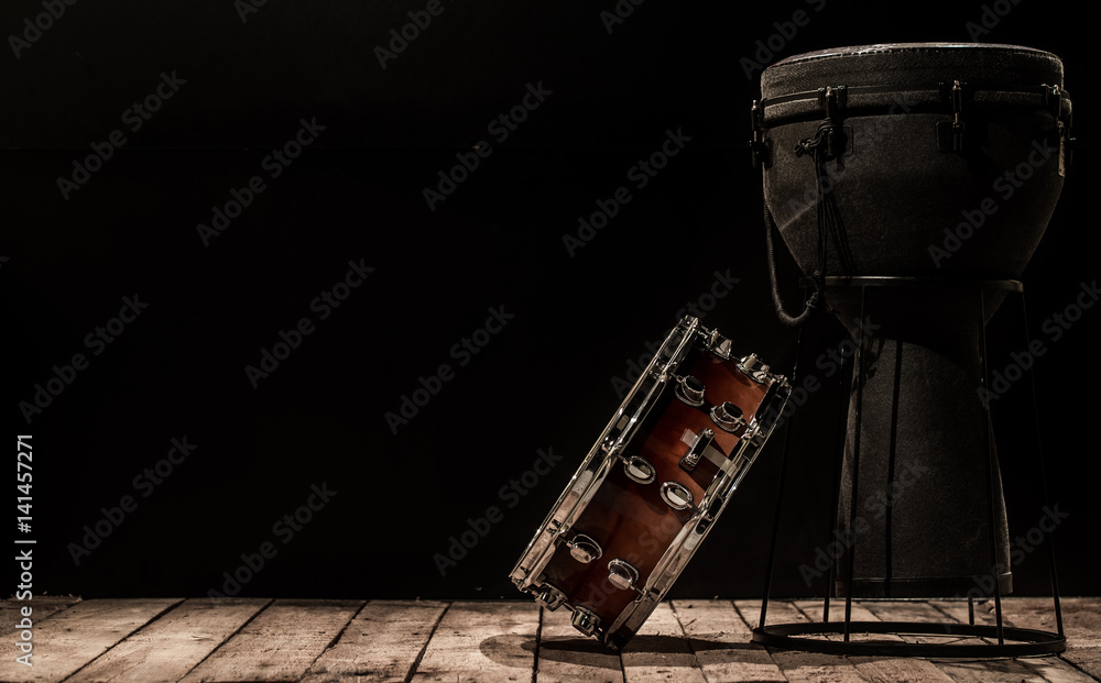 Fototapeta premium musical percussion instruments on black background drum Bongo and snare