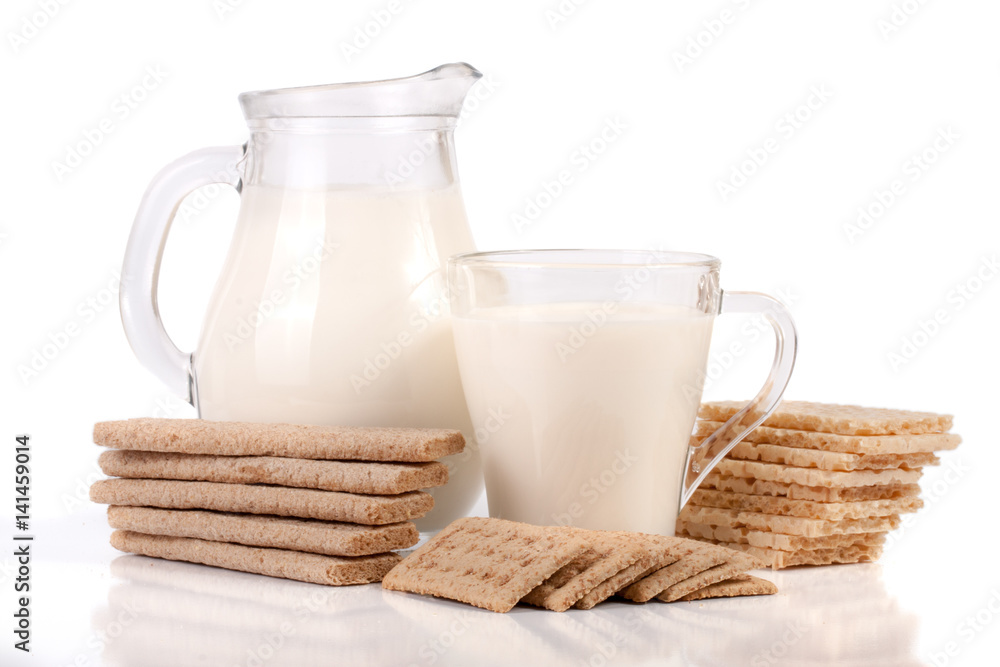 jug and glass of milk with grain crispbreads isolated on white background jug and glass of milk with grain crispbreads isolated on white background