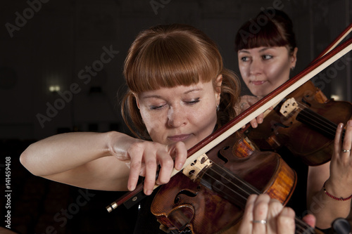 Musician play violin on dark