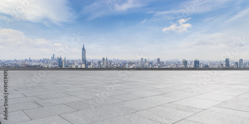Panoramic skyline and buildings with empty concrete square floor photo