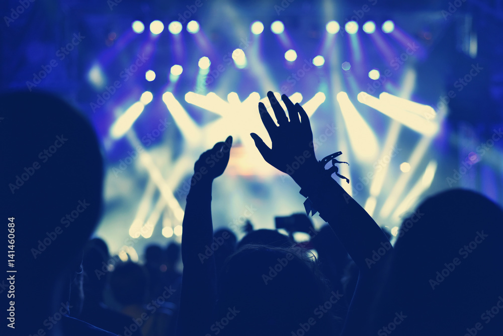 Crowd with arms outstretched at concert