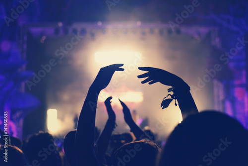 Crowd with arms outstretched at concert