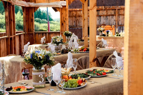 very nicely decorated wedding table with plates and serviettes.