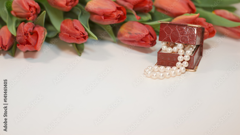 Red spring tulips with small box with pearls romantic present Red spring tulips with small box with pearls romantic present