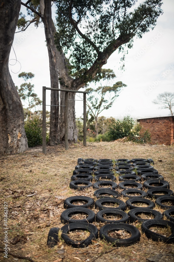 Obraz premium Boot camp with tyres obstacle course and fitness trial