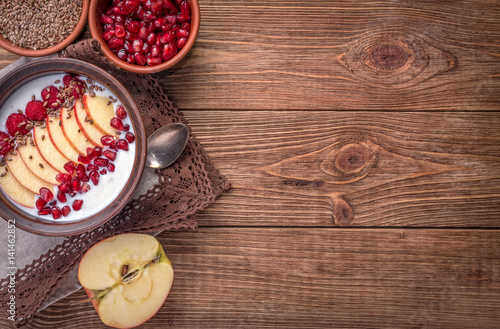 Yogurt with banana, kiwi fruit , raspberries ,garnet and flax seeds for healthy breakfast . 