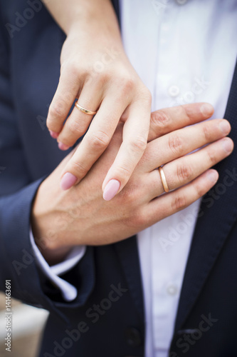 Loving hands of a man and woman with wedding rings