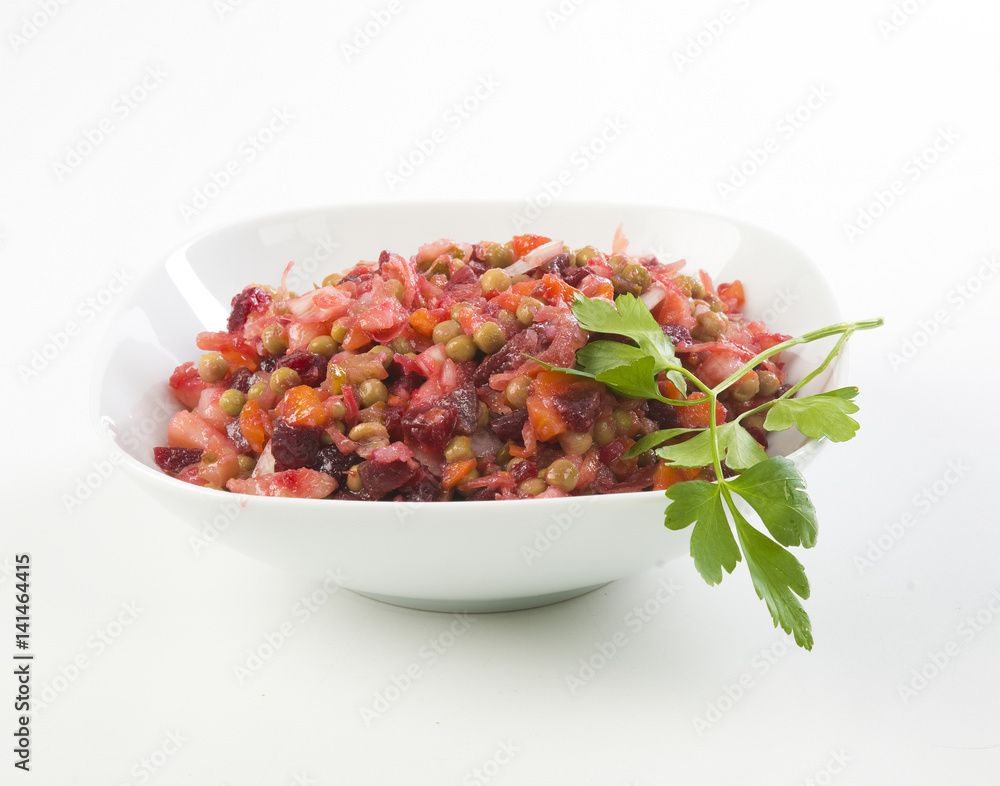 Russian beetroot salad vinaigrette White plate on checkered napkin on white background Russian beetroot salad vinaigrette White plate on checkered napkin on white background