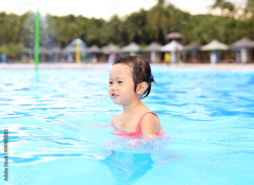 Pretty little girl in swimming pool outdoors © zilvergolf