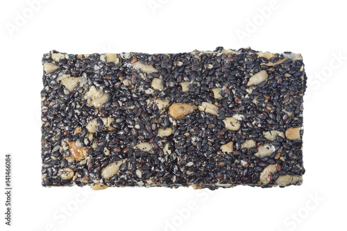 Black sesame bar mixed with sunflower seeds isolated