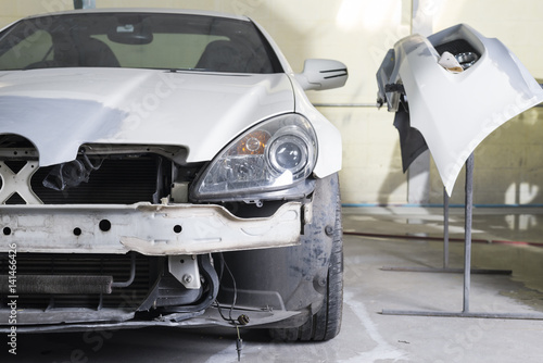 Auto body repair series : Closeup of white sport car waiting for repaint