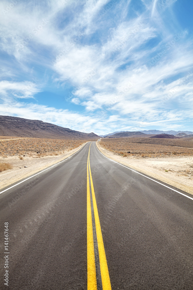 Endless desert road in Death Valley, travel concept.