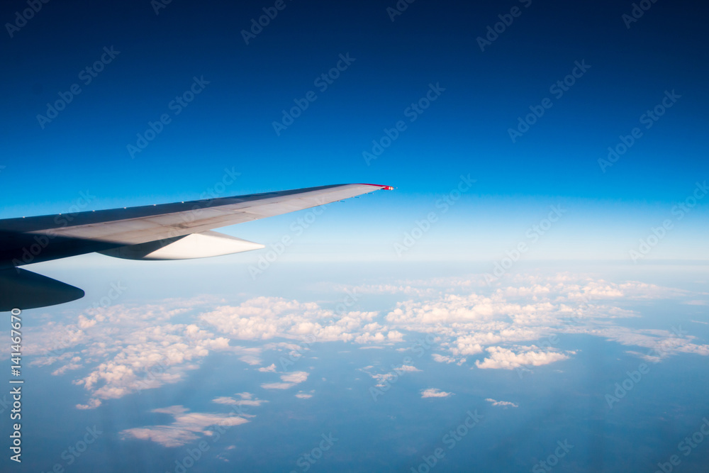 The wing of an airplane flying in the sky The wing of an airplane flying in the sky