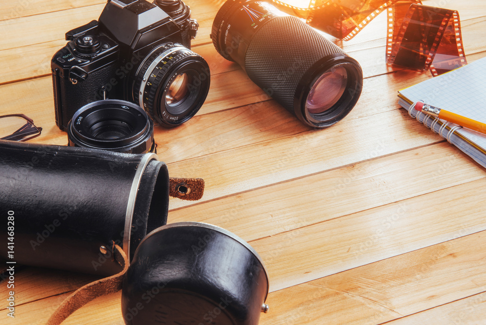 Old film camera and a roll of on wood Old film camera and a roll of on wood