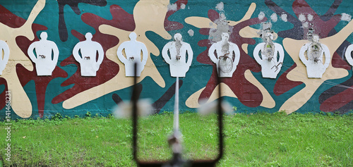 Wall of outdoor shooting gallery or shooting target photo