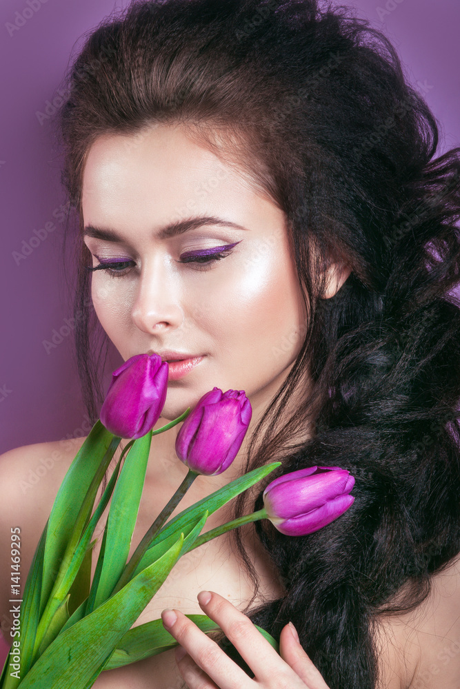 Portrait of romantic young woman with pink flower looking at camera . Spring fashion photo. Inspiration of spring and summer. Perfume, cosmetics concept. Portrait of romantic young woman with pink flower looking at camera . Spring fashion photo. Inspiration of spring and summer. Perfume, cosmetics concept.
