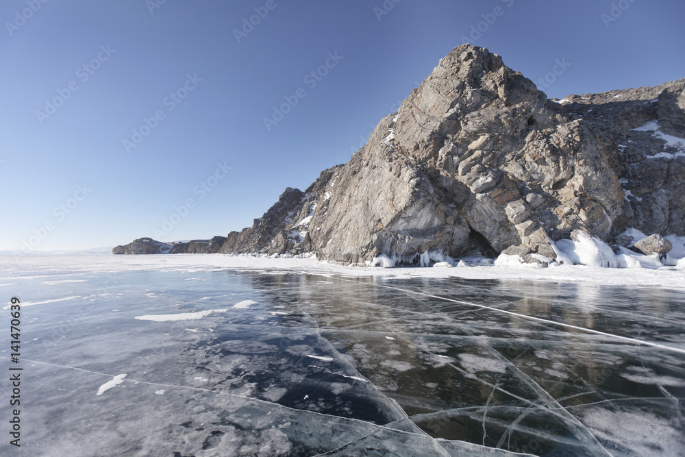 Winter landscape with cracks in ice of Lake Baikal, Oltrek island.