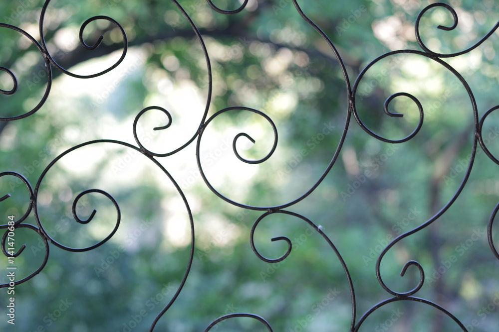 fence made of wrought iron on a green background Stock Photo | Adobe Stock