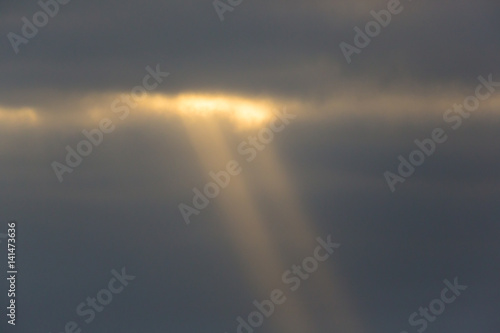 natural sunbeam with clouds in gray sky © Pascal Halder