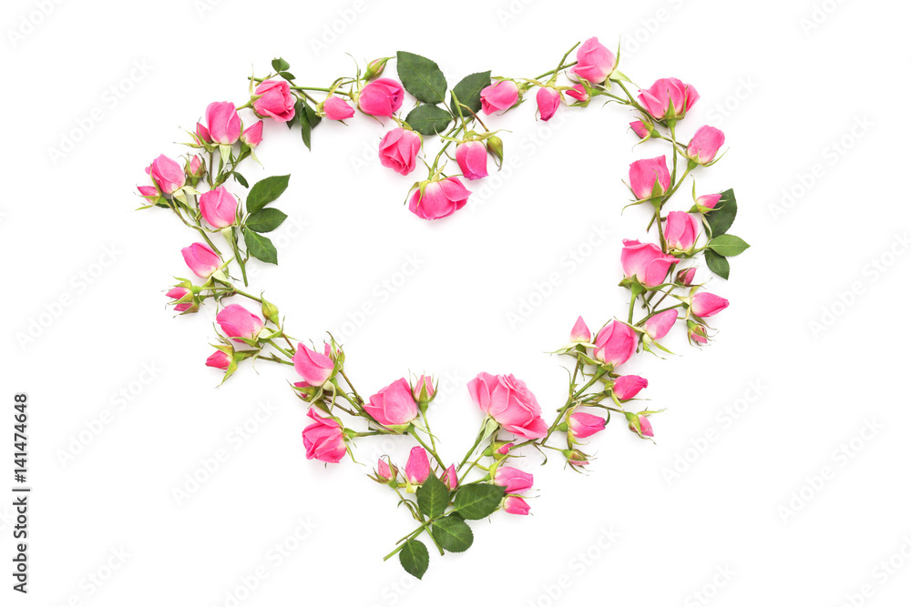 Small pink roses in the shape of heart on a white background
