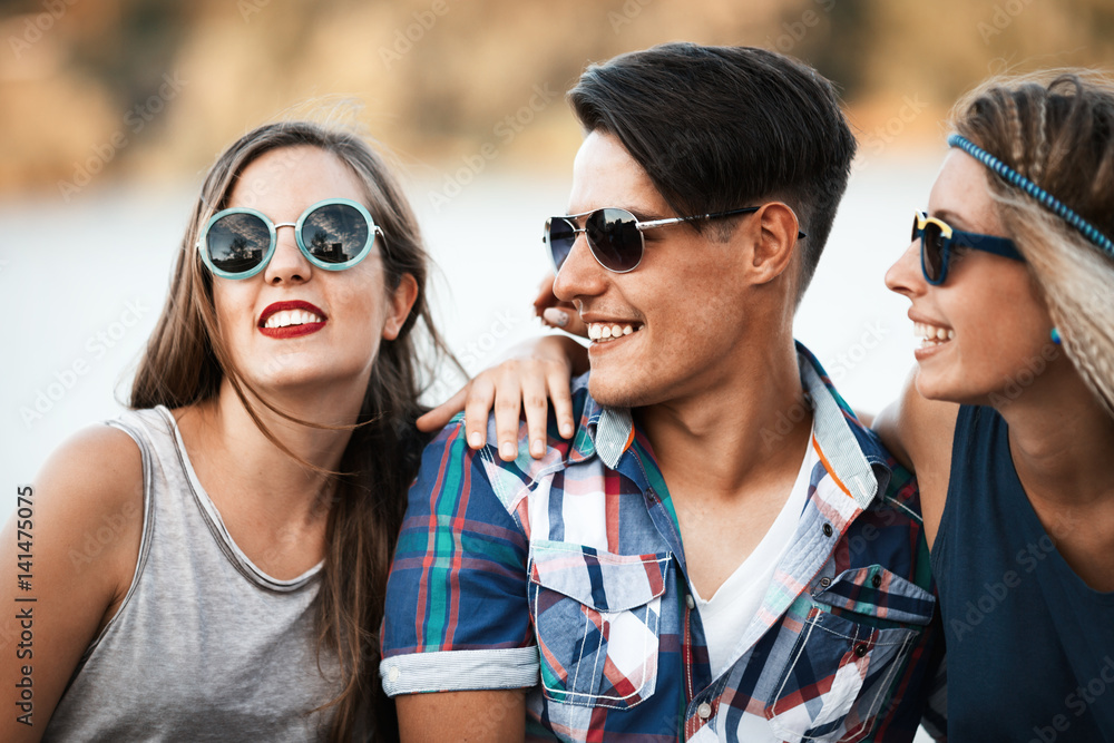 Happy friends laughing and smiling outdoors Happy friends laughing and smiling outdoors