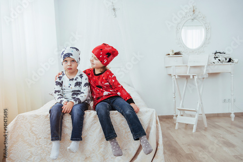 Child in soft warm pajama playing in bed photo