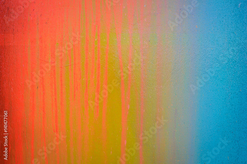 Part of a stone wall with colorful paint marks, paint texture, paint sprayed wall with colorful stains and flowing paint