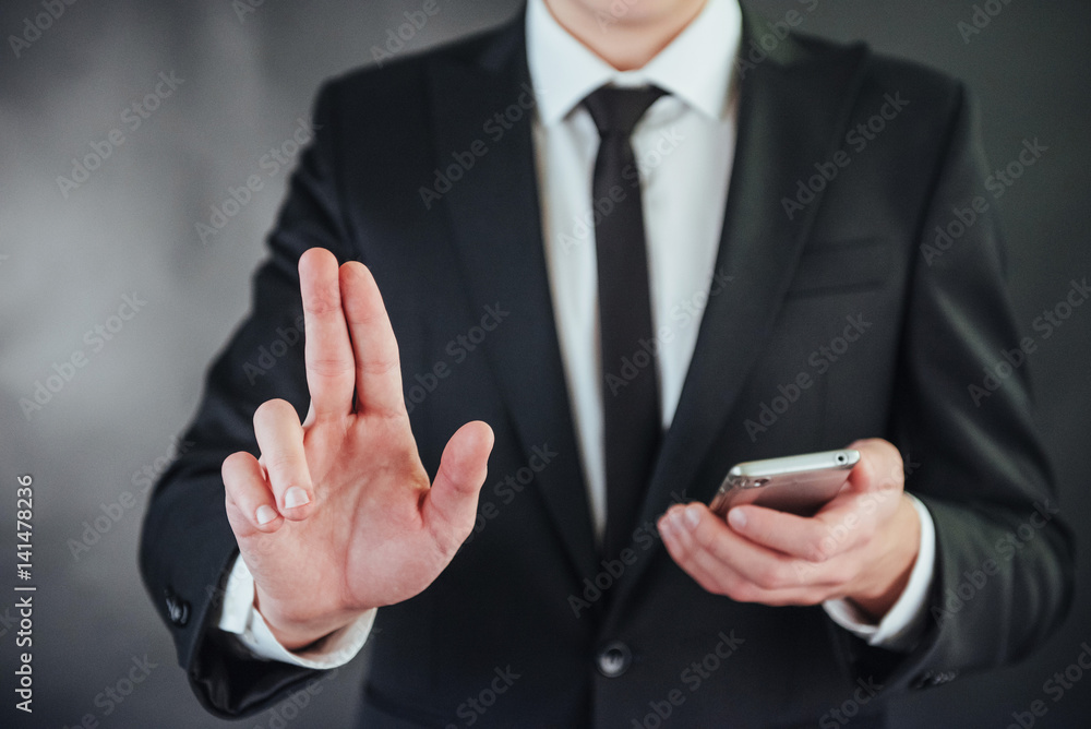 Businessman hand pointing on empty space on black background Businessman hand pointing on empty space on black background