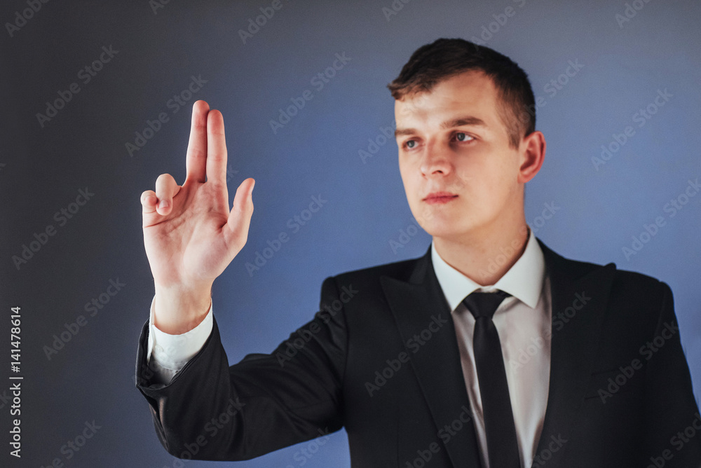 Young businessman in a suit shows his hand Young businessman in a suit shows his hand