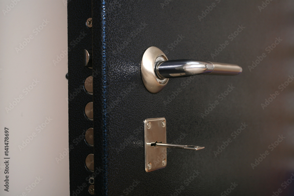 The handle on the metal safe door The handle on the metal safe door