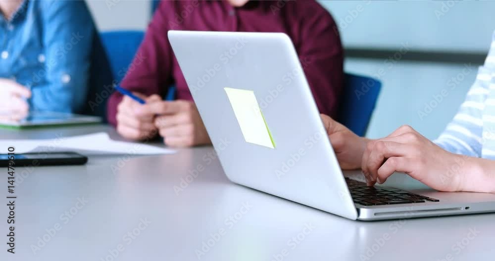 hands typing on laptop computer keyboard in office during conference hands typing on laptop computer keyboard in office during conference